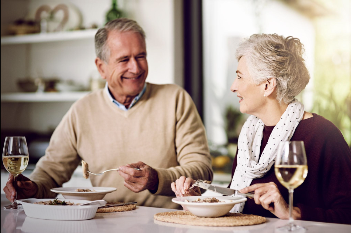 Mature couple having dinner together and talking